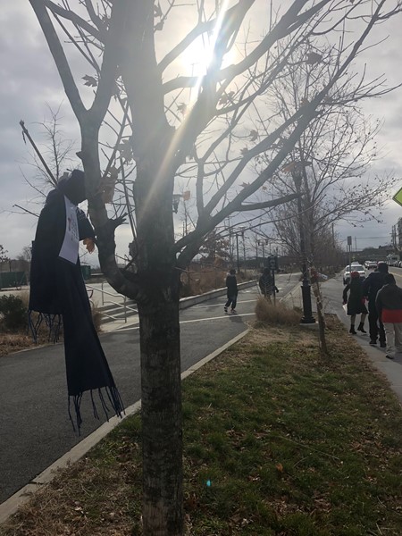 DLEACS students hang scarves on trees in Berry Lane Park.